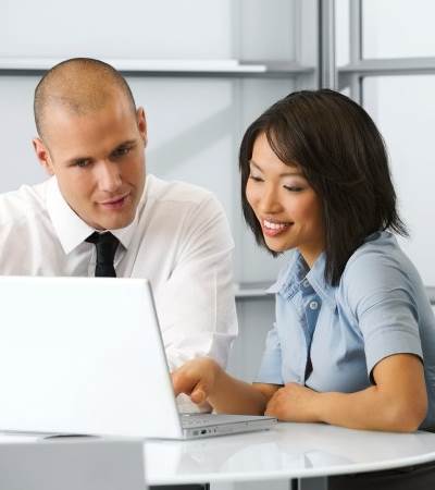 Man and woman looking at computer